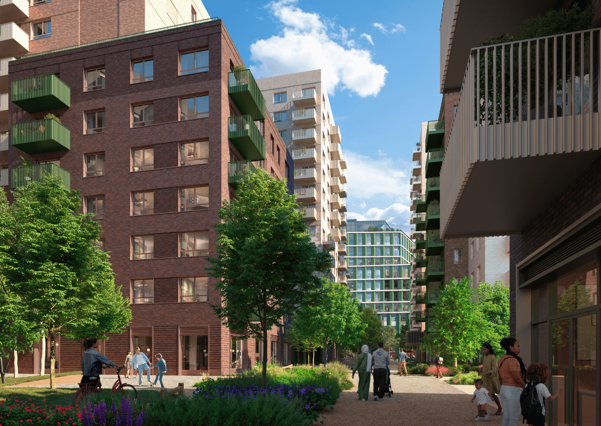 Vacant town centre development site beside a railway station, with cranes and new apartment blocks under construction